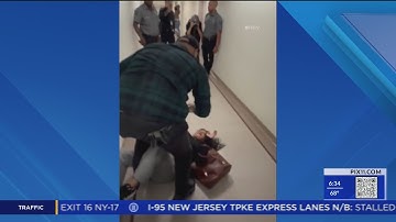 ICE agent seen shoving woman to the ground in Immigration courthouse