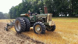 Oliver 2255 FWA with Cat 3150 plowing with 8 bottom flex back plow.