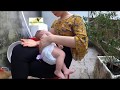 2 months old baby Thinh is breastfeeding outside backyard with having a sun tan
