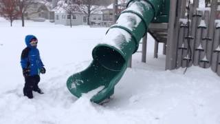 Dare devil girl sleds down slide at park