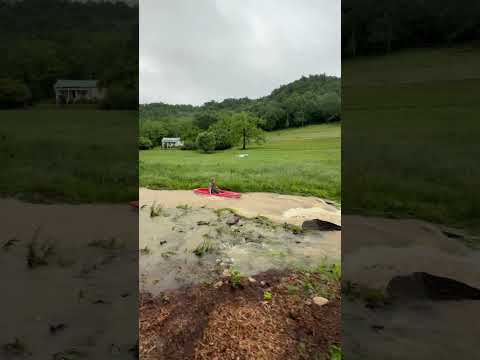 ￼ Kayaking down flooded creek