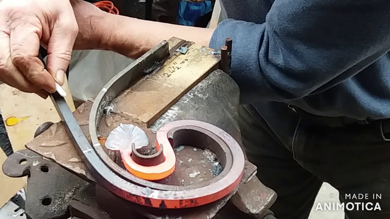 Forging a trivet with a jig and some tools.