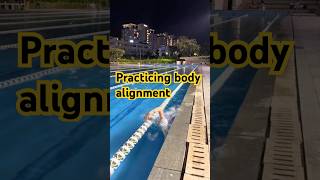Practicing body alignment while swimming freestyle and feeling stability is essential #swimming