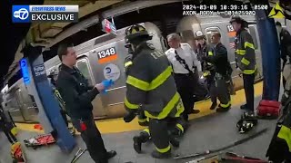 ESU officers rescue woman pushed to subway tracks and hit by train