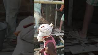 The wall is being plastered, these people are very hardworking men
