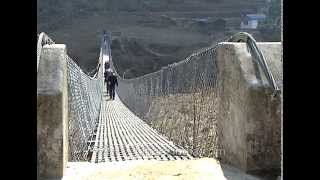 Crossing a suspension bridge during Everest expedition