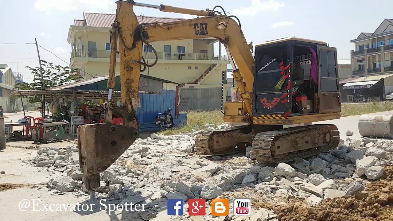 Excavator Breaking Dropping Rocks And Excavator Working On Road