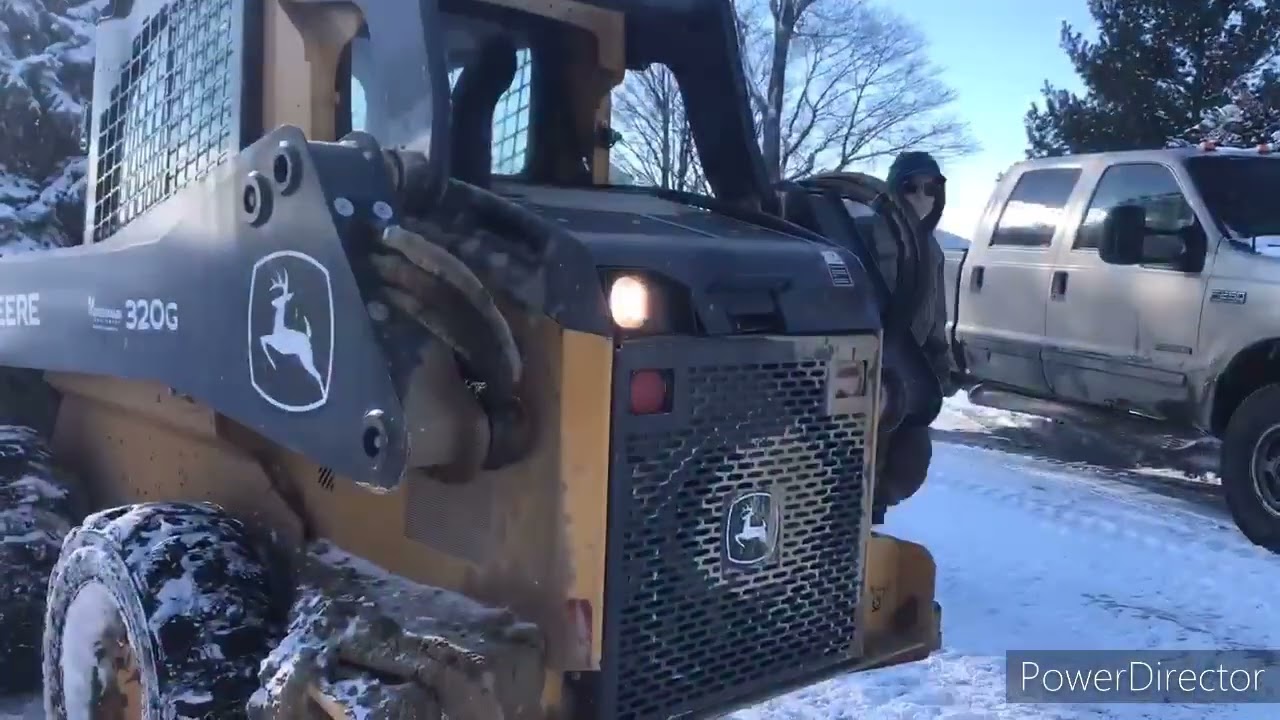 Snow plowing with John Deere 320G