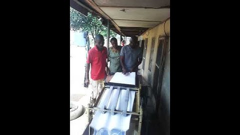 Mrs.  Mary testing and enjoying her Exercise book ruling machine made by Vester Royal.