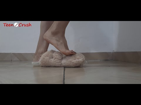 Teddy bear trample  on with bare feet.