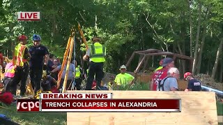 Officials work to save man from collapsed trench