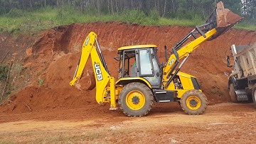Jcb at work ## Jcb Loading soil into a dump truck