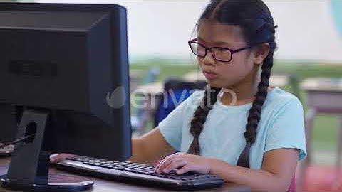 Young girl in school classroom working on computer | Stock Footage - Envato elements