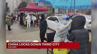 China locks down third city