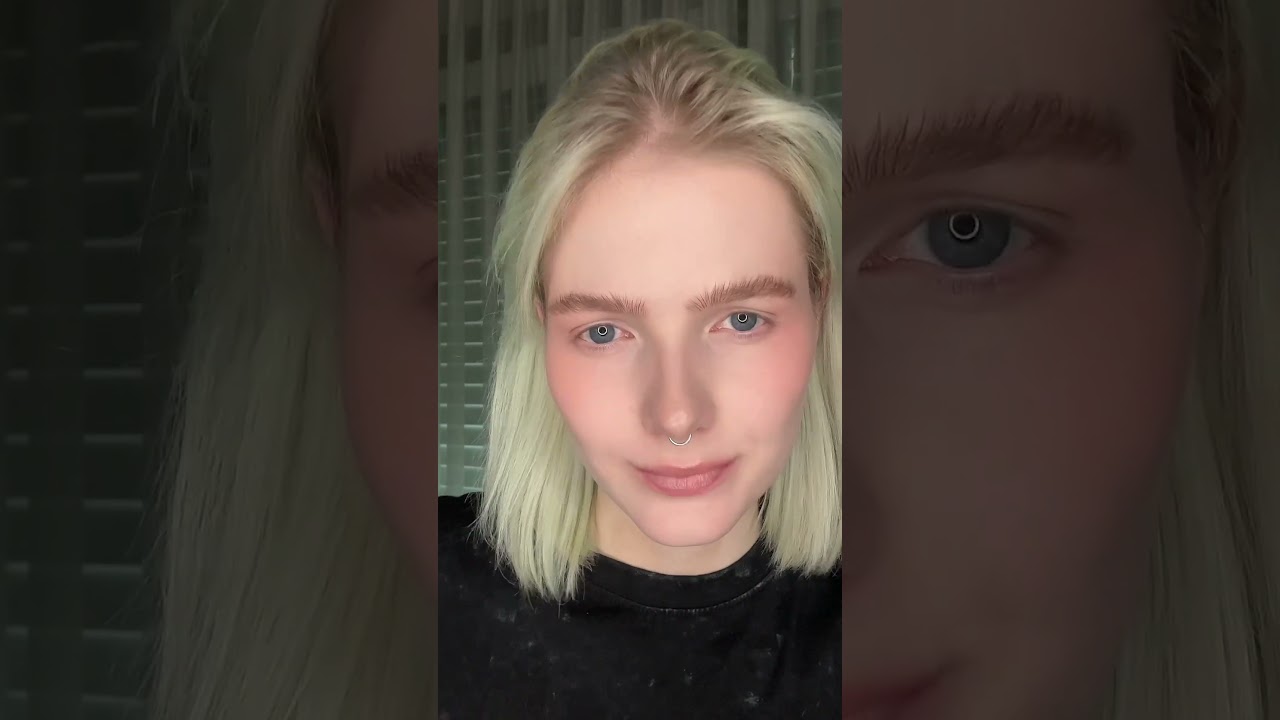 Grey grunge makeup with red mascara and concealer lips