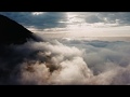 Полет в облаках среди Алматинских гор после дождя