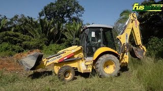 New holland B95 B Backhoe digs and moves soil