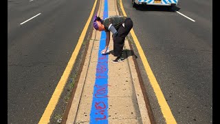 Protester defaces blue line tribute to NYPD