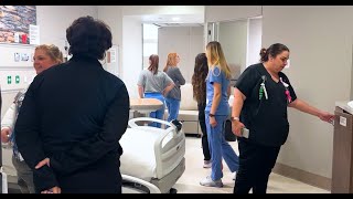 Team members move through mockup of new hospital space