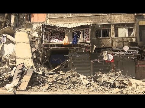 Shopkeepers view damage on commercial street in Gaza