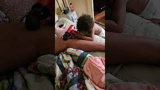 Messiah massaging his mommy leg