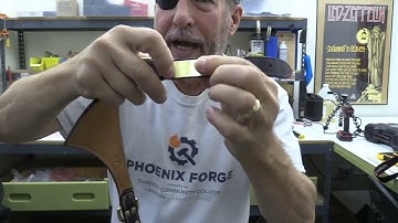 Install rivet on nameplate on dog collar