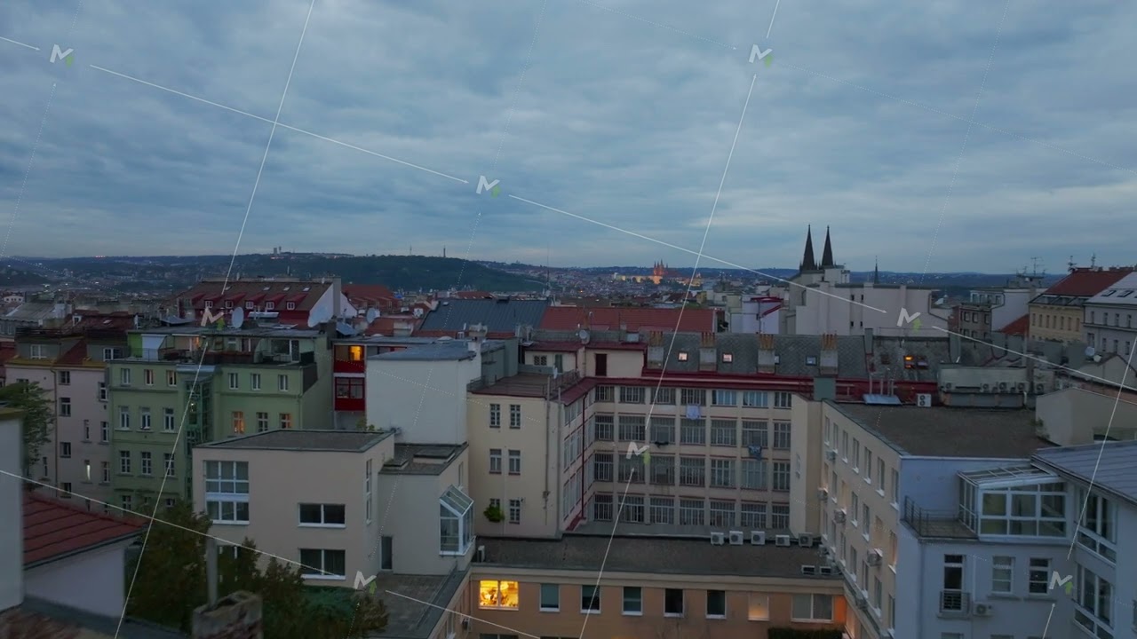 Late evening sky darkens over Prague, revealing a stunning cityscape. Rooftops adorned with