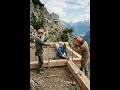 Three men are building a house with a panoramic window