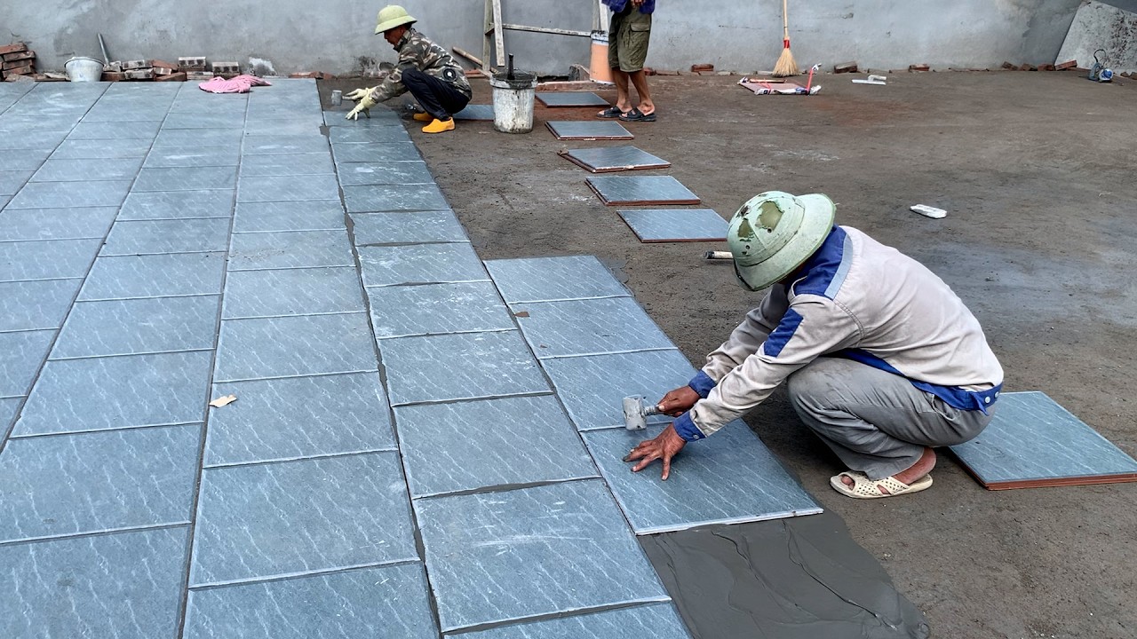 Installing 50x50cm Non-Slip Ceramic Tiles For An Outdoor Playground.