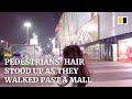 Pedestrians’ hair stood on end as they walked past a mall in China