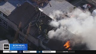 Firefighters battle blaze at two-story apartment building in Van Nuys