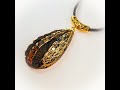 Gold on black 5 tiered pendant, polymer clay. Mixed media #2