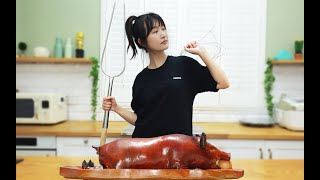 The slim girl roasts a whole suckling pig at home