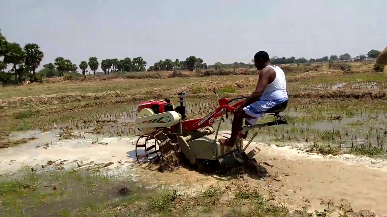 VST 135 DI Sit and drive power tiller in puddling field