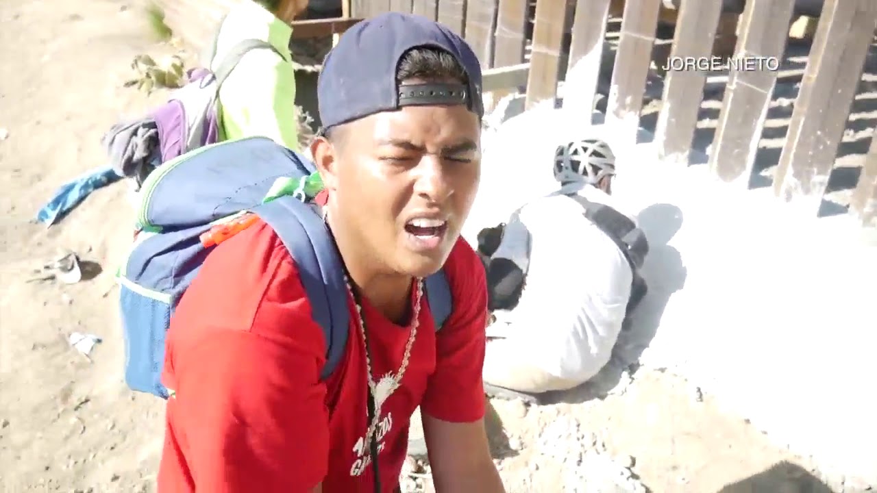 Migrants break through border fence - YouTube