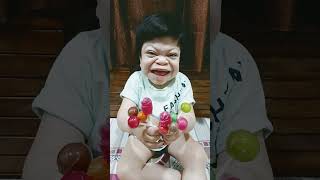cute baby loves multicolors lollipops..