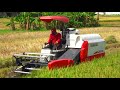 Combine Harvester Kubota DC-35 Harvesting Rice on a Large rice field