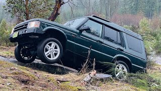 Stock Land Rover Discovery 2 takes on slippery climbs and deep water