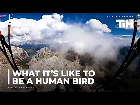 Paraglider Flies Close to Rooftops and Fields