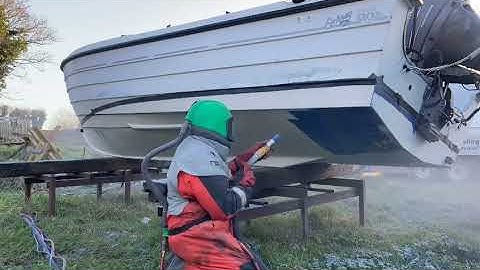 Sodablasting paint off a boat hull. This is the most cost effective way to strip paint.