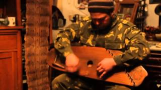 Roman Tunyakin is playing gusli (Russian cymbal) and singing old Russian folk knight ballad