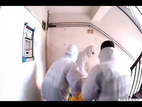 medical-personal-carrying-a-body-in-biohazard-bag-out-of-an-apartment-building-in-china-#coronavirus