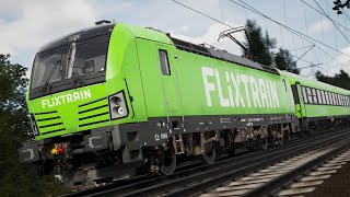 A Flixtrain BR193 Siemens Vectron and 9 Bmmz cars slowly pass Essen Kray Süd ahead of a Main Signal.