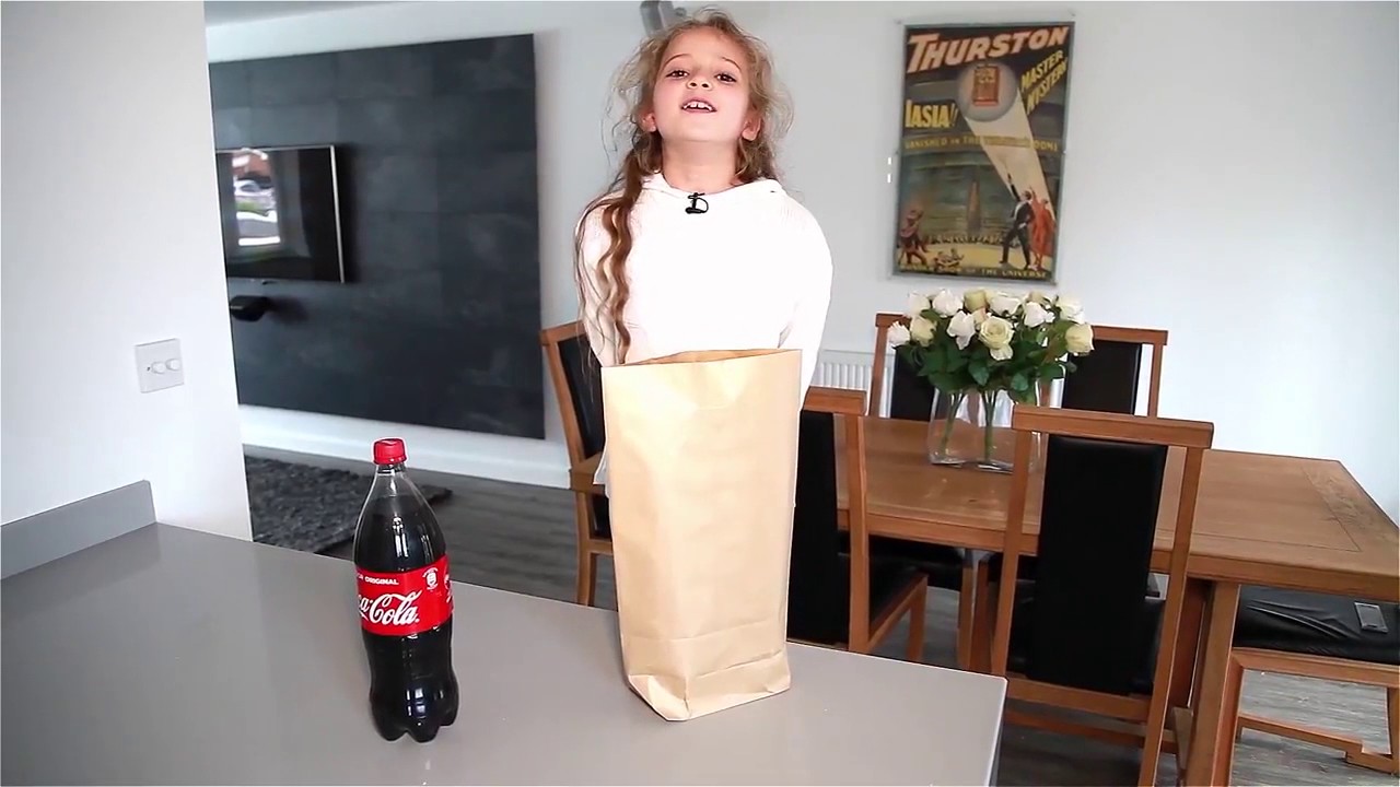 Issy Simpson performing magic with Coke Bottle