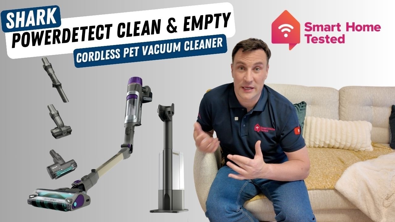 Derek from Smart Home Tested sitting on a couch beside an exploded view of all the items in the Shark PowerDetect Clean and Empty Pet Vacuum