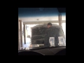 Jacob putting water in his mother's car. Has no clue.