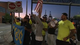 Dockworkers return to work after reaching tentative deal on wages