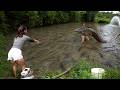 The girl unexpectedly found a large fish pond in the middle of the mountains and forest.