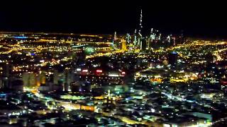 Night landing in Dubai with view of the Burj Khalifa and the Dubai Creek