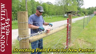 Stretching the first section of field Fence for our new pasture area.